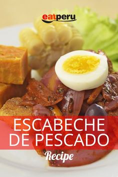 an egg is sitting on top of some meat and vegetables with the words escabeche de pescado