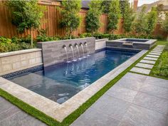 an outdoor pool with water features and landscaping