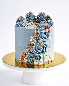 there is a blue cake with flowers on it