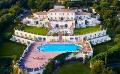 an aerial view of a mansion with a swimming pool