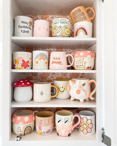 a cabinet filled with lots of cups and mugs