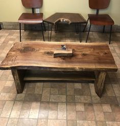 a wooden table sitting on top of a tiled floor