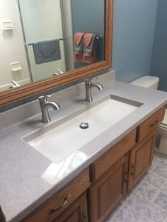 a bathroom with two sinks and a large mirror above the sink in front of it