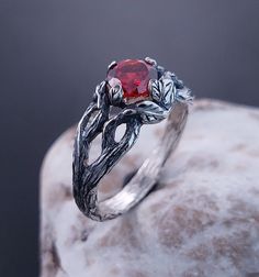 Unique Celtic Pattern Garnet  Ring, Forest Leaves Branch Ring, Garnet  Stone Leaf Ring, Gift For Her This is a nature lover's dream. A unique engagement ring created by nature itself, a Silver Branch with great texture and graceful leaves that wrap around your finger, with an Garnet sparkling between them. DETAILS: Stone - 6mm  Metal - recycled solid Sterling Silver Finish - oxidized View all silver forest rings: https://www.etsy.com/shop/TinyShinyJewel?ref=seller-platform-mcnav&section_id=43358995 Care instructions: To care for the ring, avoid contact with water and chemicals such as perfumes and lotions. When the ring is not in use, store it in a dry, cool place to prevent tarnishing. Additional information:  ✦ All rings are made to order. An average turnaround time is 1-5 days. I will m Skyrim Engagement Ring, Mystical Gemstone Rings For Formal Occasions, Sterling Silver Fantasy Style Promise Ring, Mystical Style Silver Promise Ring, Mystical Silver Promise Ring, Silver Fantasy Promise Ring, Mystical Rings With Accent Stones For Anniversary, Magical Gemstone Promise Ring, Mystical Anniversary Rings With Accent Stones