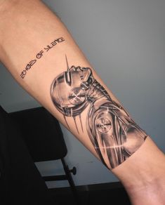 a man's arm with a star wars tattoo and darth vader helmet on it