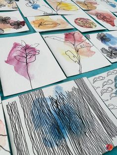 art work is displayed on the table for children to learn how to draw flowers with colored pencils