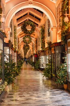 an empty shopping mall with christmas decorations on the ceiling