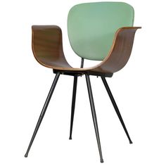 a green chair sitting on top of a black metal frame stand with two wooden legs