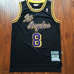 the los angeles lakers basketball jersey is on display in front of a wooden floor with wood floors