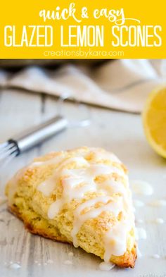 a lemon scones with icing on top and a fork next to it in the background