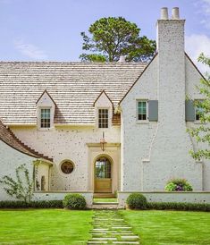 a white brick house with stone steps leading to the front door