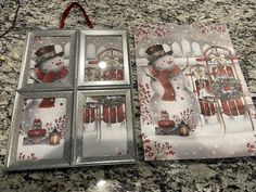 three christmas cards with snowmen on them sitting next to each other in front of a window