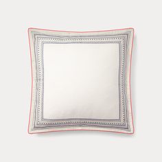 a white pillow with blue and red trim