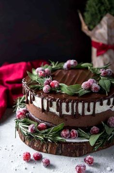 a chocolate cake with frosting and berries on top