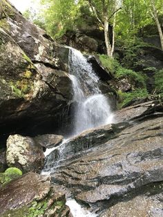 there is a waterfall in the middle of some rocks