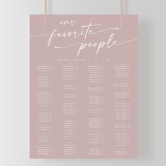 a pink and white wedding seating chart on a hanger with the words our favorite people written in cursive font