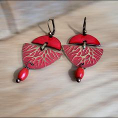 red earrings, red enamel and patterned brass earrings, designer earrings, unique gift, women's Christmas They are very bright Created from two pieces of copper that I enameled with a superb red color and two other pieces of brass that I cut, structured and patinated in red. I associated my main pieces with bronze-colored metal elements as well as two coral beads placed in suspension Dimensions total height: 6.5cm width: 3.5 cm Red Hand Painted Earrings For Gift, Red Enamel Vintage Earrings, Red Enamel Pierced Earrings, Vintage Red Enamel Earrings, Red Pierced Enamel Earrings, Red Metal Drop Earrings, Red Hand-painted Dangle Earrings, Red Hand Painted Dangle Earrings, Red Hand Painted Drop Earrings