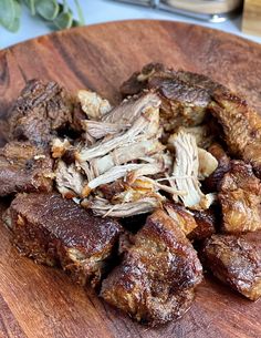 a wooden plate topped with sliced up meat