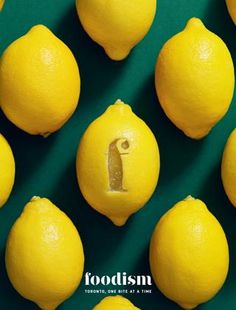 a group of lemons sitting next to each other on a green surface with the word foodism written in it