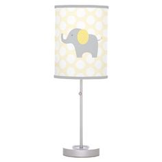 a lamp with an elephant on it and polka dot fabric shade in yellow, white and grey