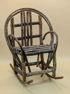 an old wooden rocking chair sitting on top of a white floor next to a wall