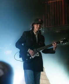 a man playing an electric guitar on stage