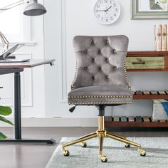 an office chair in front of a desk with a clock on the wall behind it