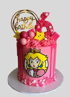 a pink birthday cake with an image of princess peach on the top and happy birthday sign above it