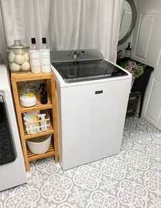 a small kitchen with a white refrigerator freezer next to a washer and dryer