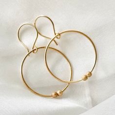 🌷These gorgeous gold filled beaded hoop earrings, have been handmade. The 2x 3 mm gold filled sparkle beads can move around the hoops. These stylish medium sized hoops will make a wonderful Christmas gift for a girlfriend, or birthday gift for your sister, or even a lovely self gift to add to your own jewelry collection. 🌷Earring size:30mm x 30mm 1.2mm gauge 14k gold filled Two 3 mm gold filled stardust beads 🌷Delivery: Your earrings will arrive gift wrapped and in a lovely gift pouch and wil Delicate Gold Hoop Earrings For Everyday, Delicate 14k Gold Filled Hoop Earrings For Everyday, Dainty 14k Gold-filled Hoop Earrings For Everyday, Hypoallergenic Dainty 14k Gold Filled Hoop Earrings, Hypoallergenic 14k Gold-filled Hoop Earrings, Dainty Everyday Earrings With Tiny Beads, Dainty 14k Gold Filled Hypoallergenic Hoop Earrings, Delicate 14k Gold Filled Hoop Earrings, Dainty Yellow Gold Hoop Earrings 14k Gold Filled