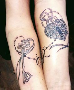 two people with tattoos on their legs and one has a key to the heart shaped lock