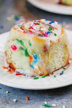 a piece of cake on a plate with sprinkles