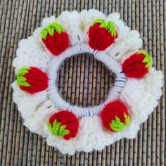 a crocheted wreath with strawberries on it