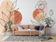 a living room with a couch, coffee table and potted plants on the wall