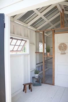 the inside of a house with white walls and wood floors