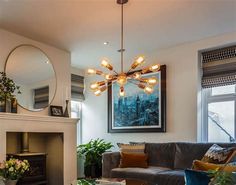 a living room filled with furniture and a fire place in front of a mirror on the wall