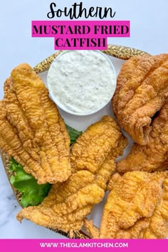 fried fish is served on a plate with ranch dip and lettuce leaves for dipping