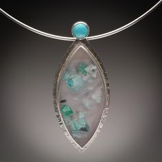 This great pendant offers a beautiful specimen of Indonesian Chrysocolla in Chalcedony cabochon, bezel set along with a Turquoise cabochon accent.  The pendant comes with an adjustable Omega style sterling silver neck wire, that measures 18 - 20 inches.  A 16 - 18 inch neck wire also available. Unique Turquoise Cabochon Pendant Necklace, Turquoise Agate Teardrop Jewelry, Chrysoprase Cabochon Pendant Jewelry, Turquoise Teardrop Agate Jewelry, Turquoise Teardrop Cabochon Necklace, Turquoise Cabochon Oval Pendant Jewelry, Elegant Chrysocolla Cabochon Necklace, Turquoise Cabochon Chrysocolla Necklace, Turquoise Cabochon Pendant Jewelry