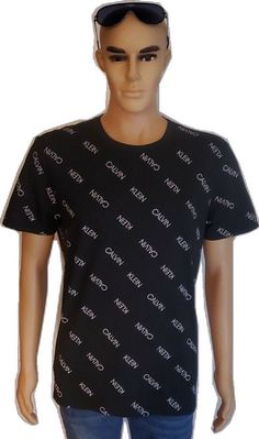 Calvin Klein Black T-shirt For Streetwear, Calvin Klein Logo Print T-shirt For Streetwear, Calvin Klein Graphic Crew Neck T-shirt, Calvin Klein Graphic Print Crew Neck T-shirt, Calvin Klein Crew Neck Graphic T-shirt, Calvin Klein Black Cotton Tops, Casual Black Calvin Klein Top, Calvin Klein Logo Print T-shirt For Summer, Calvin Klein Black Casual Top