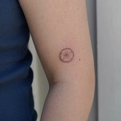 a woman's arm with a small tattoo on the left side of her arm