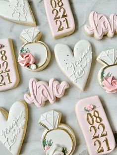 decorated cookies with the names and date on them are laid out in front of each other