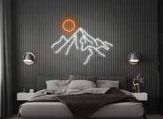 a large bed sitting under a neon mountain sign