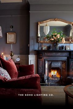 a living room filled with furniture and a fire place under a mirror on the wall