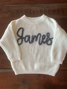 You can change these for the name you wish or phrase. List it in the personalized box Our adorable NEW hand embroidered "Name" sweaters are perfect for birth announcements, newborn/family photos, baby shower gifts, birthday gifts or any occasion! Embroidery is done by hand and can vary. Every sweater is one of a kind as they are all customized with name, sweater color and embroidery color! ALL CUSTOM INFO FOR YOUR ORDER WILL BE ENTERED IN THE PERSONALIZATION BOX AT CHECKOUT. **See photos in list Personalized White Sweater For Winter, White Cute Sweater With Embroidered Text, Personalized White Cotton Sweater, Cute White Sweater With Embroidered Text, Embroidery Name Sweater, Baby Sweater Embroidery Name Diy, Newborn Name Sweater, Baby Name Sweater Knit, Baby Sweater Embroidery Name