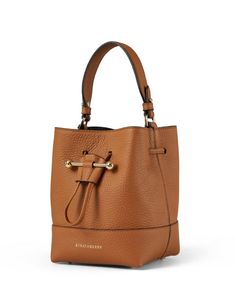 The Lana bucket bag is casual, chic and functional, making it perfect for everyday wear. The bucket silhouette is cut from premium leather, closes with a drawstring closure, and features a detachable crossbody strap for easier wear. Style it with easygoing dresses and sleek separates to instantly elevate any look. How To Wear Lug Sole Boots, Tan Bag, Lug Sole Boots, Beige Bag, Drawstring Bucket Bag, Leather Bucket Bag, Leather Bucket, Bag Style, Free Bag