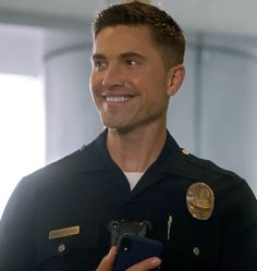 a man in uniform holding a cell phone