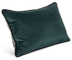 a dark green pillow with black piping on the front and side, against a white background