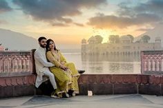 a man and woman sitting on a bench near the water