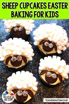 four cupcakes with marshmallows and chocolate in them on a table