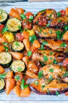 chicken, carrots and zucchini on a tray